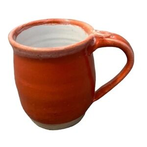 Coffee/tea mug decorated with a‎ coral glaze.